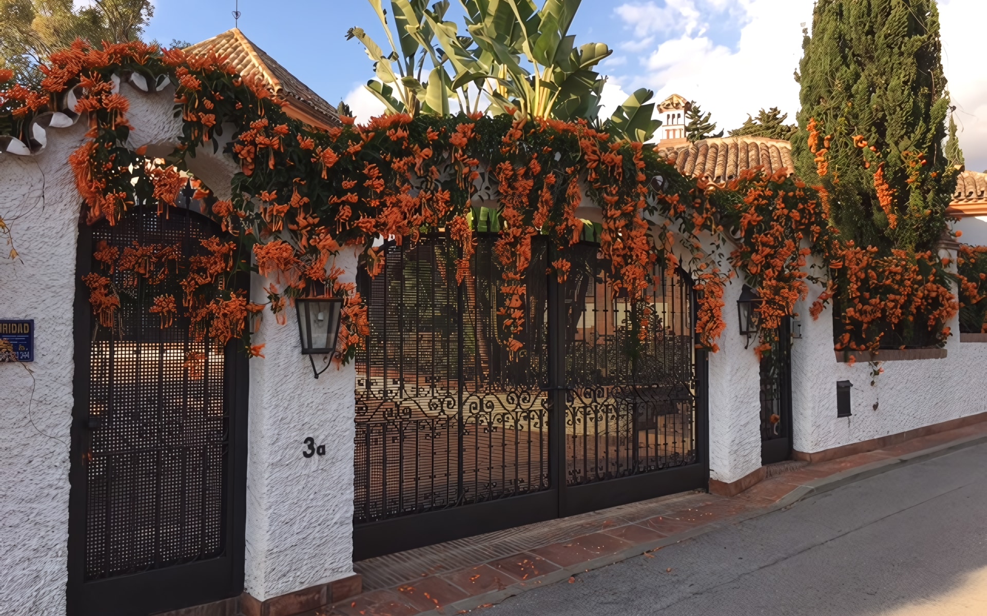 Majestic view of the Costa Bella coastal sanctuary with blooming bushes and ornate gates.