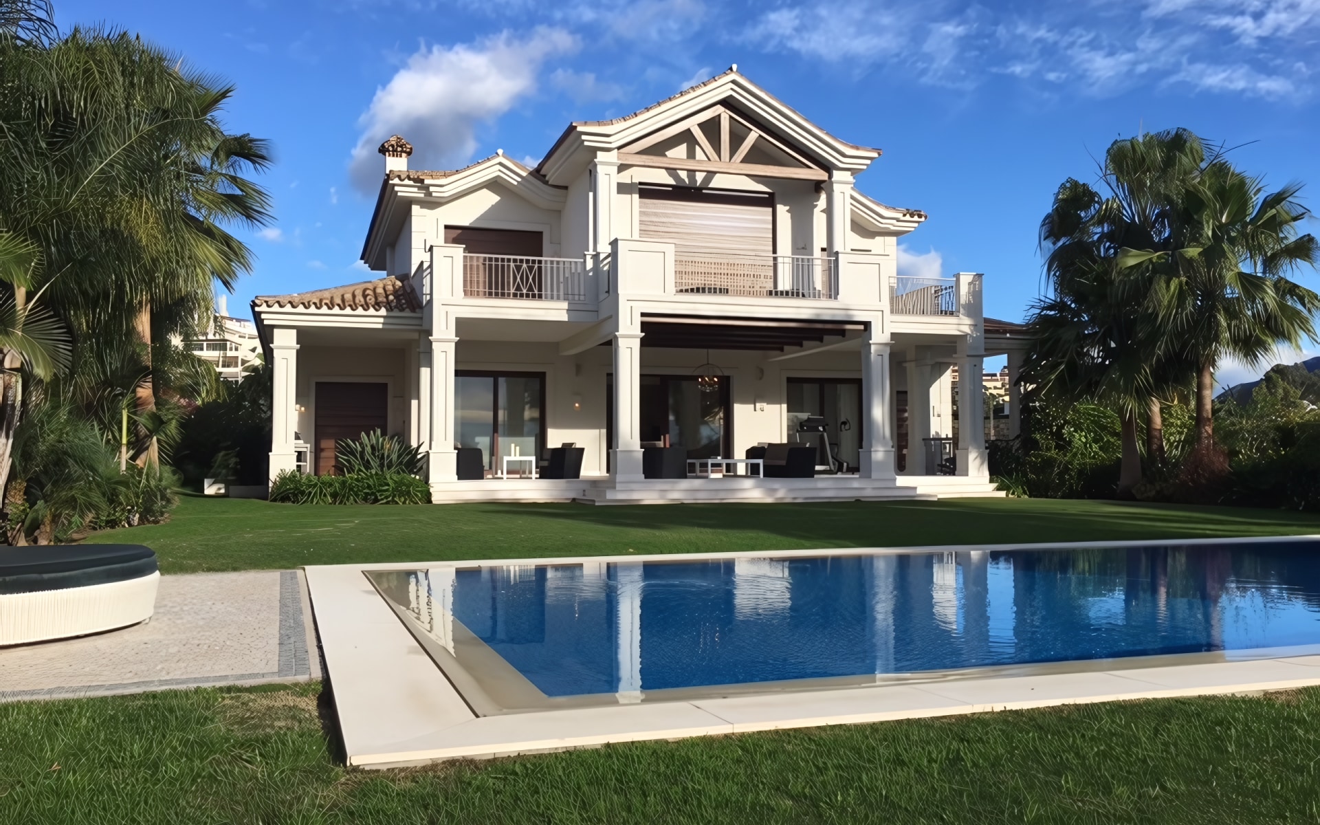 Outdoor dining area with a view of the La Cerquilla garden and villa.