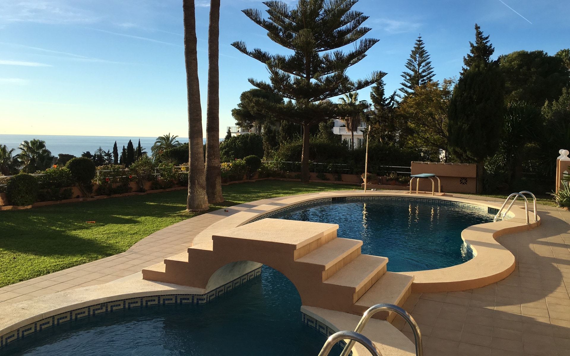 Modern pool area with lounge chairs at Torre Nueva villa.